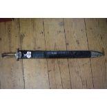 A Continental hunting sword and leather scabbard, the blade 49.5cm long.