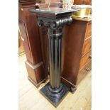 A late Victorian ebonized Ionic column pedestal, 115cm high.