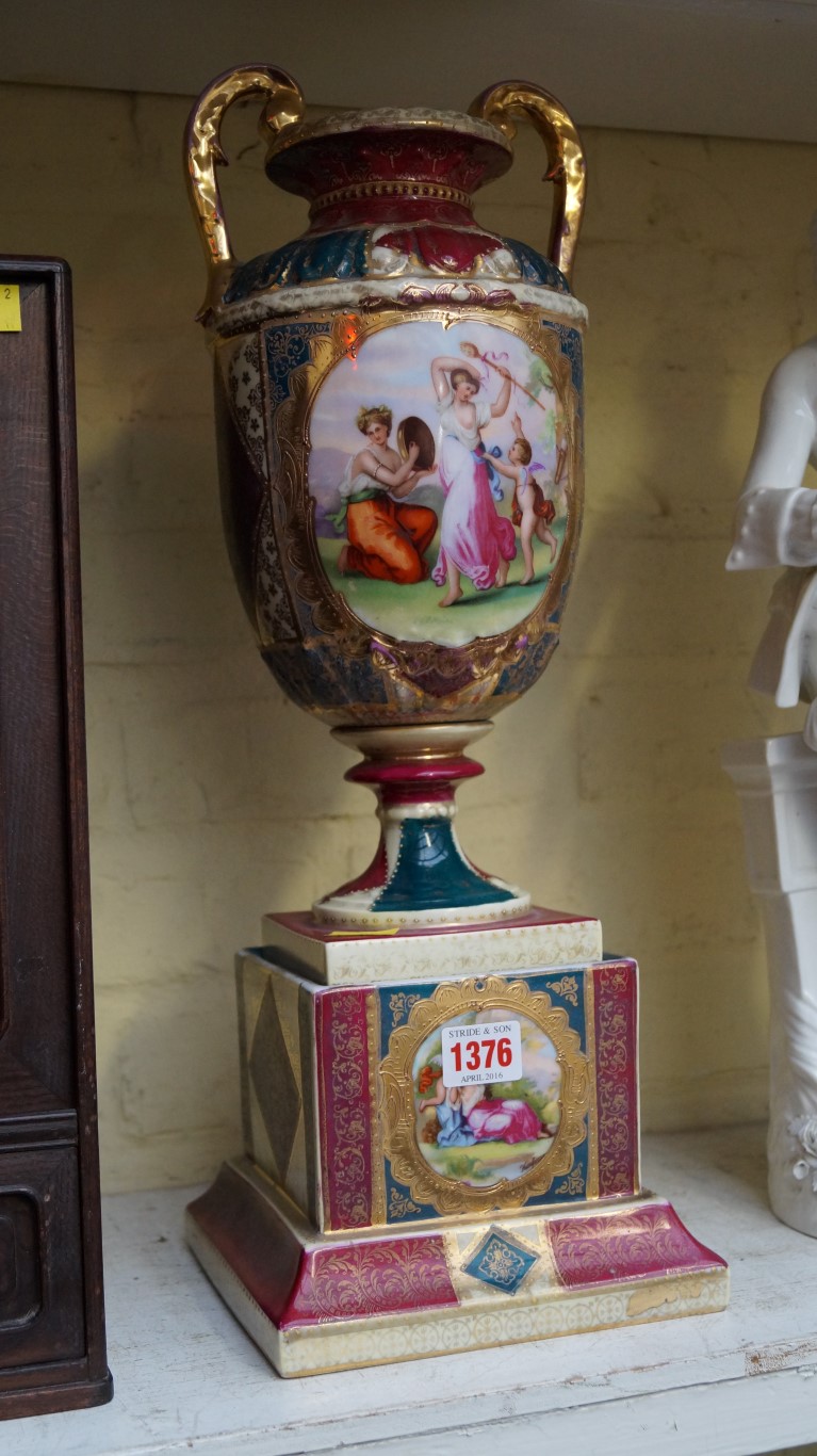 A Continental porcelain twin handled vase and pedestal, 48cm high.