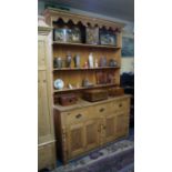 An antique pine dresser and rack, 166cm wide.