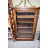 A Victorian walnut music cabinet, with glazed panel door, 55cm wide.