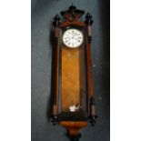 A late 19th century walnut and ebonized Vienna style wall clock, with weight driven movement,