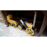 A yellow and black painted wood steam locomotive and tender model, the locomotive 38.5cm long.