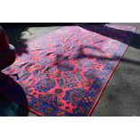 A large Turkey style red ground carpet, having allover pattern, blue bordered, 597 x 336,