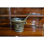 A large antique bronze twin handled mortar and pestle, the mortar 20cm high.