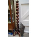 An antique mahogany bedpost standard lamp, with spiral turned column and cabriole base.