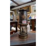 A 'Patterson Lamps Ltd' steel and brass miner's type lamp, 24cm high.