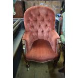 A Victorian carved mahogany framed and button upholstered occasional armchair.