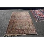 A Persian cream ground rug, having allover floral design, 210 x 135cm.