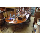 A George III style mahogany twin pedestal dining table, with two additional leaves,