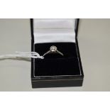 An unmarked white gold diamond solitaire ring, approximately 0.