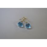 A pair of 14ct gold blue topaz and diamond tear drop earrings.