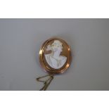 A 9ct gold framed carved shell cameo brooch, decorated classical lady.