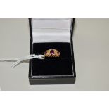 An 18ct gold garnet and diamond ring (not ruby).