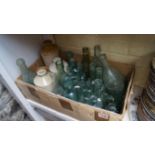 A quantity of old glass and stoneware bottles.