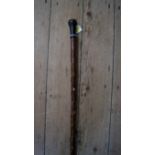 An antique briarwood folk art cane, scratchwork decorated allover with figures,