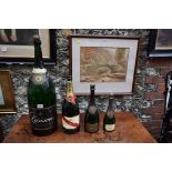 Two Krug champagne advertising bottles; together with a magnum Mumm champagne bottle;