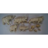 A collection of carved ivory animals, comprising: a lion, 17cm long, (repair to tail); a rhino, 9.