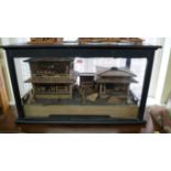 An unusual wooden diorama of Japanese buildings, in an ebonized case, 74.