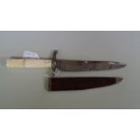 An 18th century French dagger and sheath, with ivory handle, silver guard and etched blade,