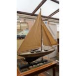A painted pond yacht, the hull 69.5cm long.