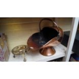 A Victorian copper helmet form coal scuttle; together with a brass trivet.