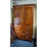 An early 19th century mahogany linen press, the pair of panelled doors now enclosing hanging space,