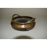 A Chinese bronze twin handled tripod censer, Xuande six character mark, 16cm diameter.