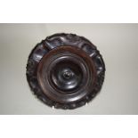 An interesting Chinese hardwood stand, Qing dynasty, possibly Zitan, 18cm diameter.