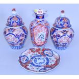 Four pieces of Japanese Imari porcelain, comprising: a pair of vases and covers, 25cm high; a vase,