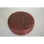 An Oriental cinnabar lacquer circular box and cover, 17cm diameter.