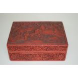 An Oriental cinnabar lacquer rectangular box and cover, 21.5cm wide.