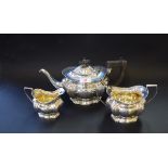 An Edwardian silver three piece tea set, by William Aitken,