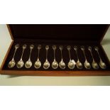 A cased set of twelve RSPB silver gilt teaspoons, by John Pinches, London 1975, 330g,