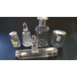 Three silver lidded glass containers and three silver mounted scent bottles.