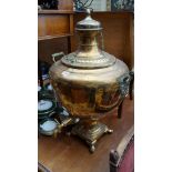 An oversized antique brass samovar.