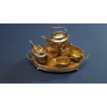 An Edwardian miniature silver four piece tea set and tray, by CS FS, Birmingham 1904/5,