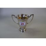 A silver twin handled trophy cup, by Harrods Ltd, London 1932, 10cm, 89g.