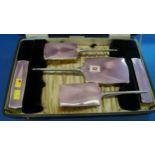 A cased silver and pink enamel five piece dressing table set, by Daniel Manufacturing Company Ltd,