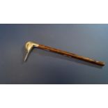 A silver duck head parasol handle, by J S, London, having cabochon garnet eyes, length of head 7.