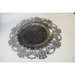 A large continental metal dish, pierced with continuous band of Eagle and Lion crests to rim,