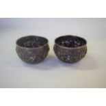 A pair of Eastern metal bowls, decorated figures, 7.5cm diameter.