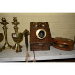 An old wall mounted oak and brass telephone.