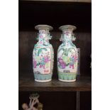 A pair of Chinese famille rose vases, 25.5cm high.