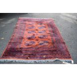 A Bokhara style rug, having two rows of elephant pad medallions.