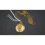 A continental yellow metal St Christopher medallion on fine yellow metal necklace.