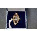 An unusual 14k gold ring decorated Lion face and set with four diamonds.