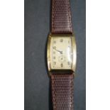 A vintage unsigned 14k gentleman's wristwatch, having on leather strap.