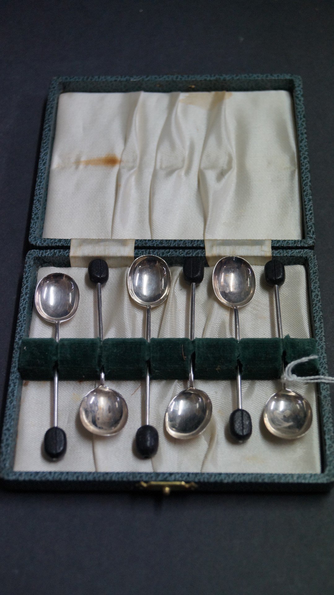 A cased set of six silver coffee spoons with bean handles, by Cooper Brothers & Sons,