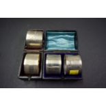 A cased pair of Edwardian silver napkin rings, by J D & S,